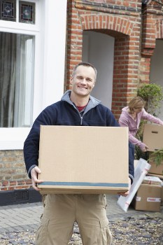 Furniture removals team loading items in Queens Park street setting