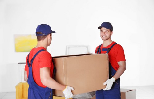 Professional packers organising household boxes in a Queens Park home