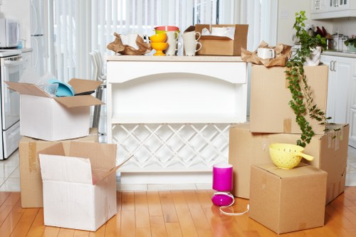 Local moving truck handling furniture and boxes in Queens Park