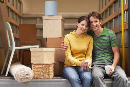 Furniture being carried during same day removals in Queens Park