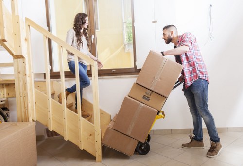 Careful wrapping of fragile items for a move in Queens Park