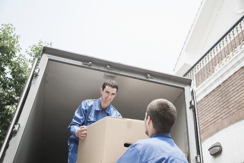Loading office items into a removals vehicle near Queens Park